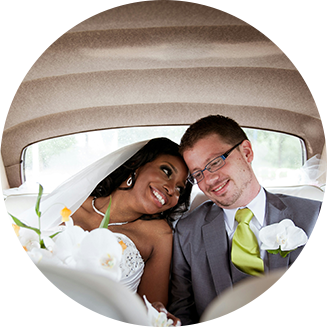 A man and woman sitting in the back of a car.