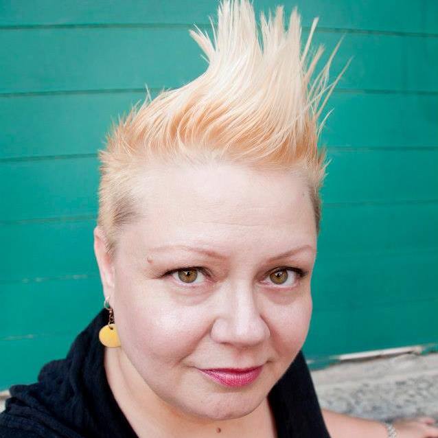 A woman with blonde hair and a black shirt