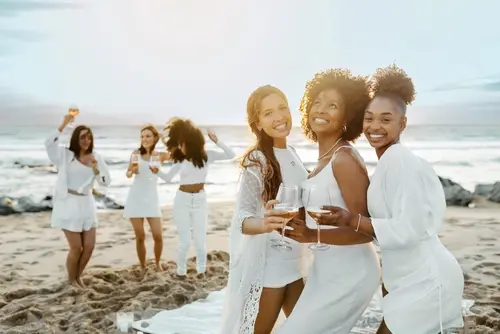 Happy,Young,Diverse,Women,Posing,With,Wine,Glasses,While,Dancing