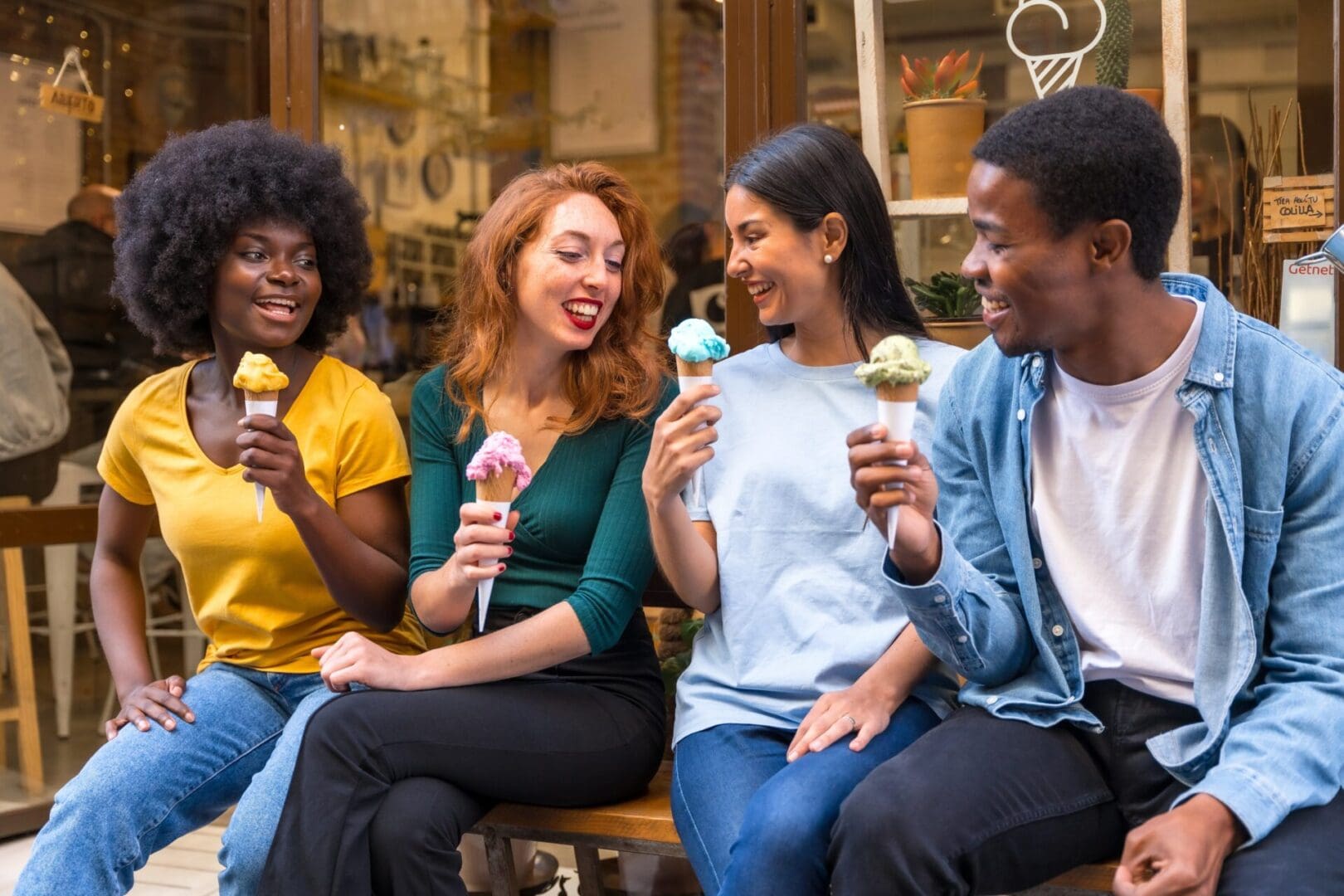 Multi-ethnic,Friends,In,An,Ice,Cream,Parlor,Sitting,Eating,An