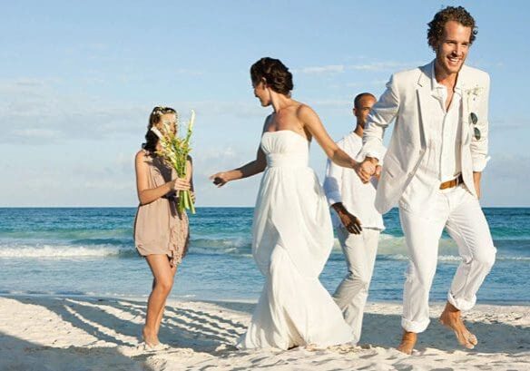 A group of people walking on the beach